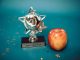 BREAKING: North Bergen Honors Educators at Annual Awards Luncheon Silver star-shaped trophy with apple on a blue background for teacher appreciation.
