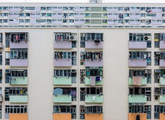 BREAKING: RHO Residential Chosen to Manage 6,000-Unit Portfolio in Jersey City Multicolored urban apartment building with balconies and windows, showcasing city living.
