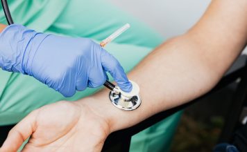 BREAKING: RWJBarnabas Donates $1.3M to Jersey City Nonprofits Healthcare professional using a stethoscope on patient's wrist during a medical exam.
