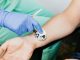 BREAKING: RWJBarnabas Donates $1.3M to Jersey City Nonprofits Healthcare professional using a stethoscope on patient's wrist during a medical exam.