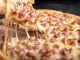 BREAKING: Top Hoboken Pizza Spots Ranked by Craving Close-up of a delicious pepperoni pizza slice with gooey mozzarella cheese.