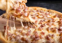 Close-up of a delicious pepperoni pizza slice with gooey mozzarella cheese.