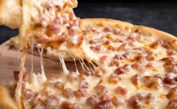 BREAKING: Top Pizza Spots in Hoboken Ranked by Craving Close-up of a delicious pepperoni pizza slice with gooey mozzarella cheese.