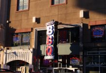 BREAKING: Two New Food Concepts Coming to Newark Avenue in Jersey City Neon signage of Dallas BBQ Restaurant illuminated in an urban environment at sunset.