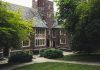 Elegant Gothic architecture of Princeton University surrounded by lush greenery on a summer day.
