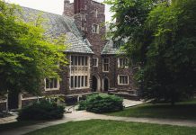 Elegant Gothic architecture of Princeton University surrounded by lush greenery on a summer day.