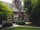 Elegant Gothic architecture of Princeton University surrounded by lush greenery on a summer day.