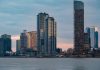 Twilight view of the iconic New York City skyline with skyscrapers and tranquil waters.