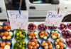 Colorful assortment of fruits and vegetables on display at a vibrant market stall.