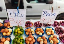 Colorful assortment of fruits and vegetables on display at a vibrant market stall.