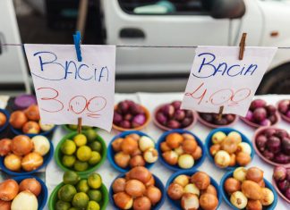 Colorful assortment of fruits and vegetables on display at a vibrant market stall.