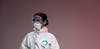 Ebola Outbreak Far Away but CDC Watching Closely — Here’s What Hudson County Needs to Know Medical professional in full protective suit with goggles and mask, studio setting.