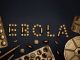 Creative arrangement of pills spelling 'EBOLA', showcasing a conceptual healthcare theme.