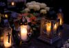 Lanterns with candles illuminate a cemetery on All Saints' Day.