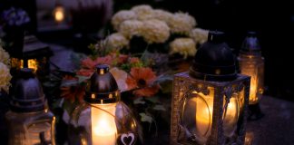 Lanterns with candles illuminate a cemetery on All Saints' Day.