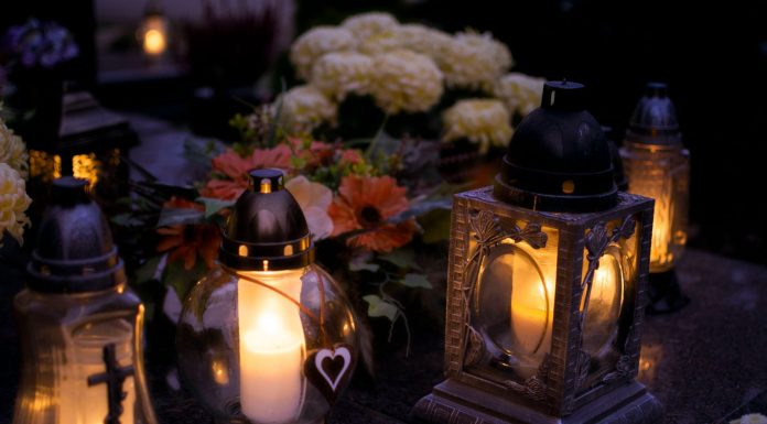 Elizabeth Says Goodbye to Cinthia D Remedios Gonzalez Lanterns with candles illuminate a cemetery on All Saints' Day.
