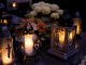 Lanterns with candles illuminate a cemetery on All Saints' Day.