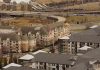 Aerial view of urban residential apartments featuring an American flag, depicting city life.