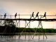 Film Screening in Jersey City Tells the Story of Teenage Migrants Unrecognizable active ethnic kids jogging on footbridge above lake while working out under sunset sky
