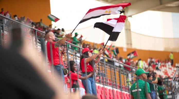 Hoboken Offers Free World Cup Tickets to Local Youth Soccer fans in the stadium wave Egyptian flags, showing their support during a lively sports match.