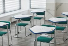 How to Get Your GED in Bayonne, NJ: Your Complete Guide for 2026 An empty classroom with arranged desks, exam papers, and pencils ready for students.