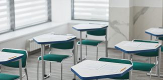 How to Get Your GED in Bayonne, NJ: Your Complete Guide for 2026 An empty classroom with arranged desks, exam papers, and pencils ready for students.