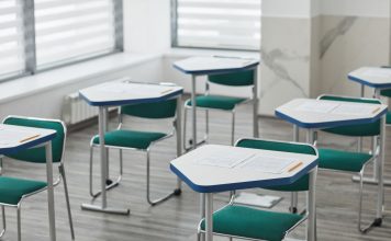 How to Get Your GED in Bayonne, NJ: Your Complete Guide for 2026 An empty classroom with arranged desks, exam papers, and pencils ready for students.