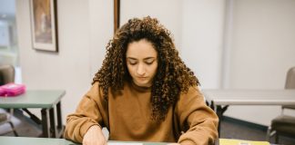 How to Get Your GED in Union City, NJ: A Complete Guide for 2026 Young woman studying for an exam in a college classroom with books and notes.