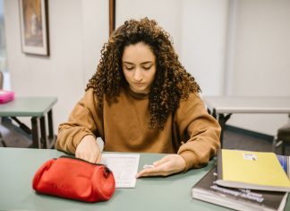 How to Get Your GED in Union City, NJ: A Complete Guide for 2026 Young woman studying for an exam in a college classroom with books and notes.