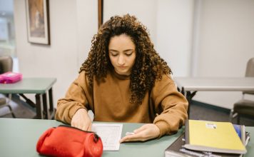 How to Get Your GED in Union City, NJ: A Complete Guide for 2026 Young woman studying for an exam in a college classroom with books and notes.