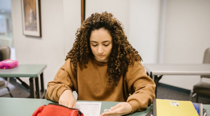 How to Get Your GED in Union City, NJ: A Complete Guide for 2026 Young woman studying for an exam in a college classroom with books and notes.