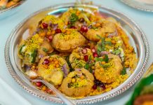Tempting plate of crunchy Pani Puri topped with colorful garnishes.