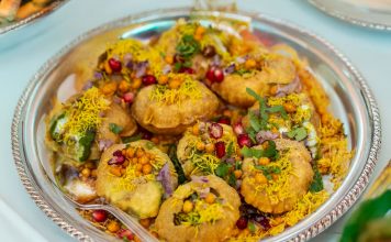 Tempting plate of crunchy Pani Puri topped with colorful garnishes.