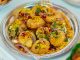 Tempting plate of crunchy Pani Puri topped with colorful garnishes.