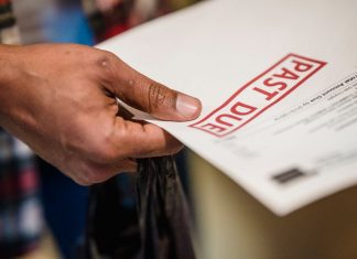 Interim report says Jersey City owes $109M in unpaid bills from Fulop administration A close-up of a hand holding a document with a 'Past Due' stamp, highlighting financial urgency.