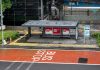 Bus stop in Jakarta, Indonesia with empty seating area and modern urban surroundings.