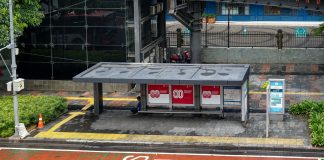 Bus stop in Jakarta, Indonesia with empty seating area and modern urban surroundings.