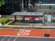 Jersey City cuts Via hours and Saturday service, saving $4M Bus stop in Jakarta, Indonesia with empty seating area and modern urban surroundings.