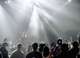 Jersey City Youth Showdown Heads to White Eagle Hall DJ performing in a lively nightclub with a crowd enjoying the vibrant atmosphere.