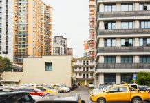 Journal Square Tower Plan Brings 150 Public Parking Spots, Affordable Units High-rise apartment buildings with parked cars in front captured in Sichuan, China.