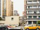 High-rise apartment buildings with parked cars in front captured in Sichuan, China.