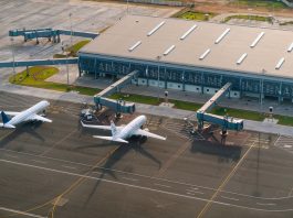 Aerial view of Abeid Amani Karume International Airport in Zanzibar, showing parked airplanes and terminal.