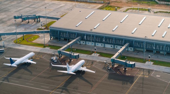 Aerial view of Abeid Amani Karume International Airport in Zanzibar, showing parked airplanes and terminal.