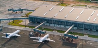Aerial view of Abeid Amani Karume International Airport in Zanzibar, showing parked airplanes and terminal.