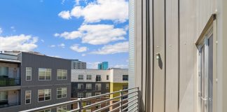 Bright and sunny view of modern urban apartments from a balcony.