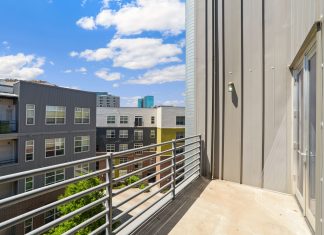 Bright and sunny view of modern urban apartments from a balcony.