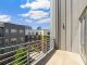 Bright and sunny view of modern urban apartments from a balcony.