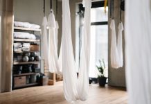 A peaceful yoga studio featuring aerial yoga hammocks for fitness and relaxation.