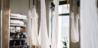 A peaceful yoga studio featuring aerial yoga hammocks for fitness and relaxation.