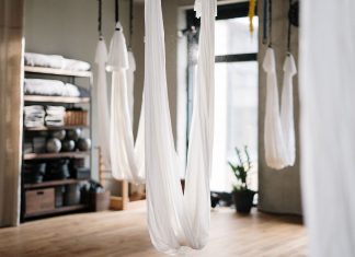 A peaceful yoga studio featuring aerial yoga hammocks for fitness and relaxation.